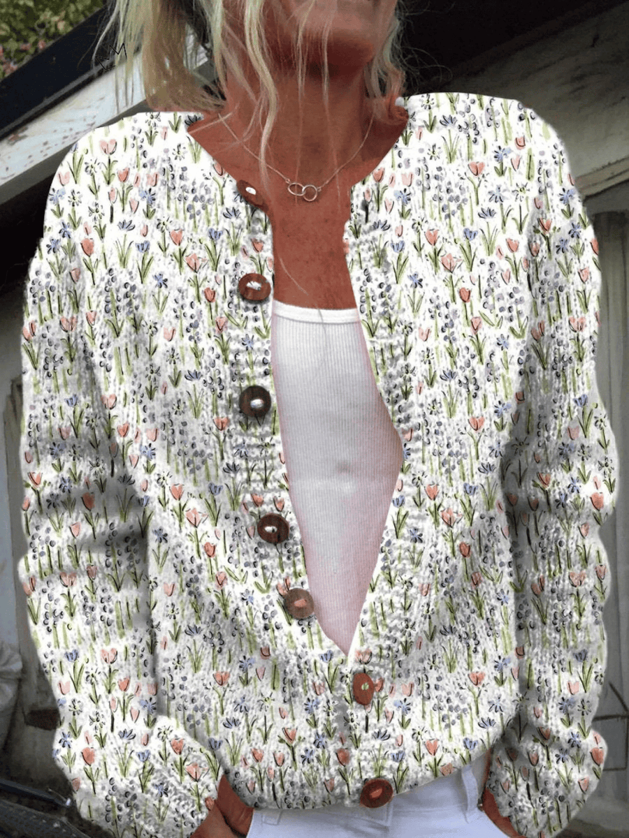 Vintage floral cardigan by THE WHITMORE FAMILY, featuring a soft knit fabric with colorful floral patterns and a classic button-up design.