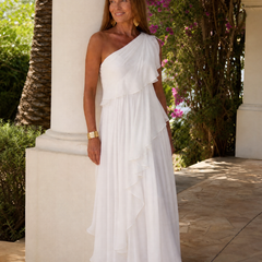 Talia cascading ruffle maxi dress by THE WHITMORE FAMILY, flowing fabric with layered ruffles and elegant design.