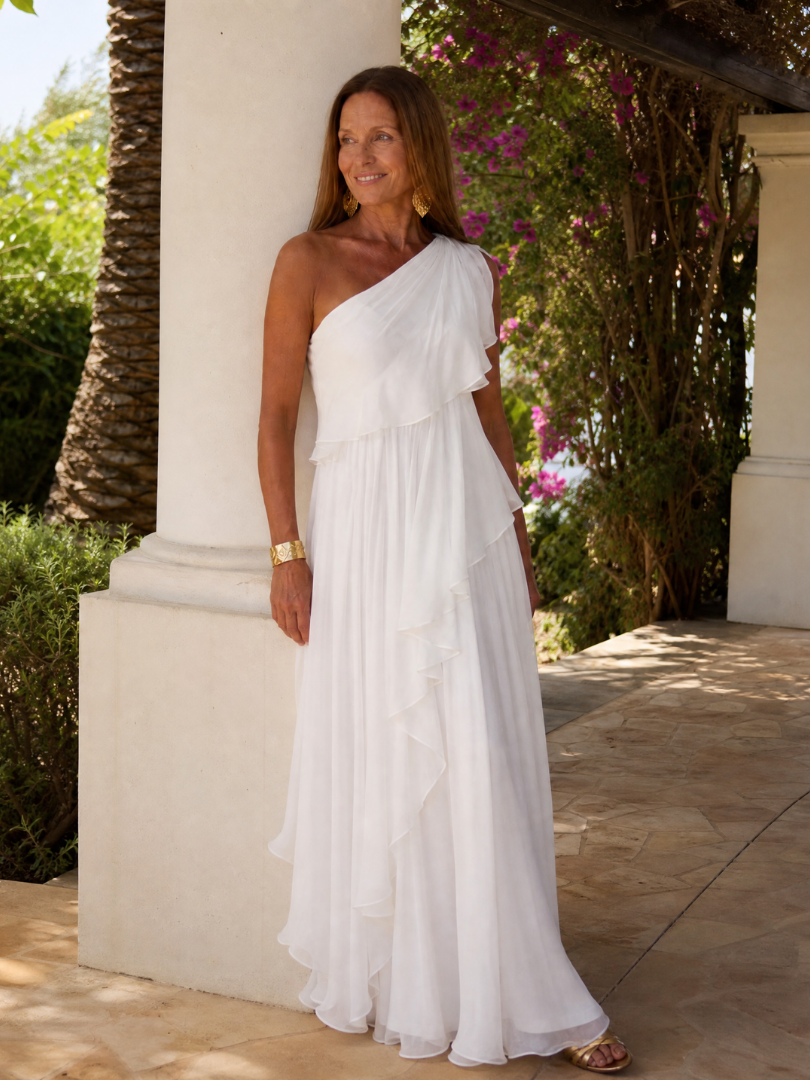 Talia cascading ruffle maxi dress by THE WHITMORE FAMILY, flowing fabric with layered ruffles and elegant design.
