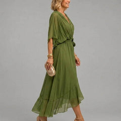 Mona V-neck dress by THE WHITMORE FAMILY, showing a stylish, flowy dress with a V-neckline and elegant design.