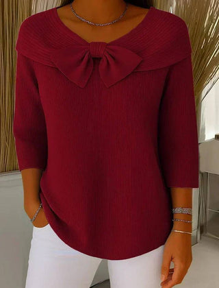 Women's sweater by THE WHITMORE FAMILY featuring a bow detail and round neckline, made of soft knit fabric.