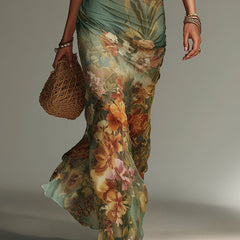 Shea floral maxi dress by THE WHITMORE FAMILY featuring a flowing silhouette and vibrant flower print.