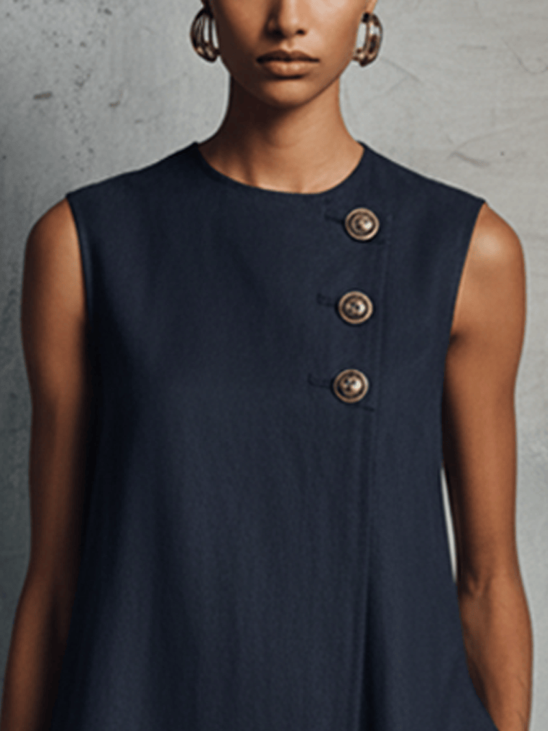 Aubrey asymmetric button mini dress by The Whitmore Family, shown in black with stylish buttons and a fitted silhouette.