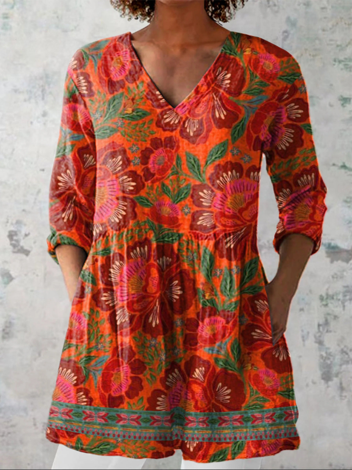Marion long blouse with V-neck by THE WHITMORE FAMILY, featuring lightweight fabric and a relaxed fit, displayed on a hanger.
