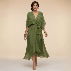 Mona V-Neck Dress by THE WHITMORE FAMILY, featuring a stylish V-neckline and elegant silhouette in a vibrant fabric.