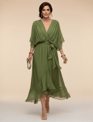 Mona V-Neck Dress by THE WHITMORE FAMILY, featuring a stylish V-neckline and elegant silhouette in a vibrant fabric.