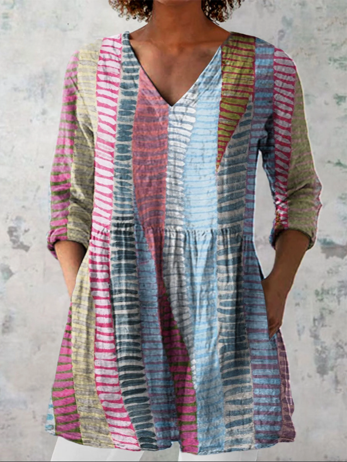 Anais long blouse with V-neck by THE WHITMORE FAMILY, displayed on a model, featuring flowing fabric and elegant design.