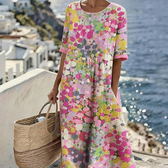Elegant floral summer midi dress by THE WHITMORE FAMILY, featuring a flowing silhouette and vibrant floral pattern.