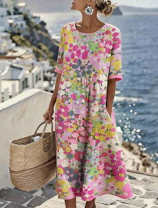 Elegant floral summer midi dress by THE WHITMORE FAMILY, featuring a flowing silhouette and vibrant floral pattern.