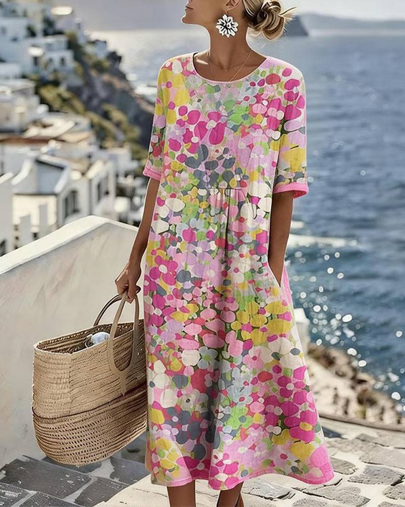 Elegant floral summer midi dress by THE WHITMORE FAMILY, featuring a flowing silhouette and vibrant floral pattern.