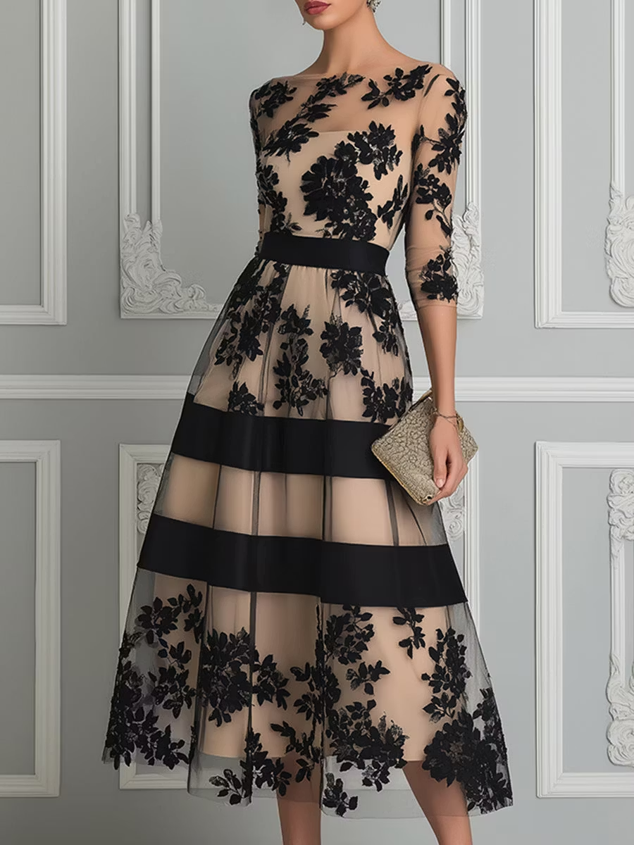 Elegant black lace midi A-line dress by THE WHITMORE FAMILY featuring intricate lace details and a classic silhouette.