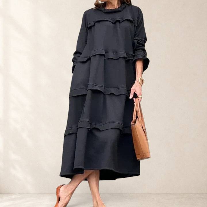 Elegant Briannelyse midi dress by THE WHITMORE FAMILY, shown in a sophisticated silhouette and neutral fabric.