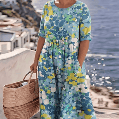 Elegant floral summer midi dress by THE WHITMORE FAMILY, featuring a flowing design and vibrant floral pattern.