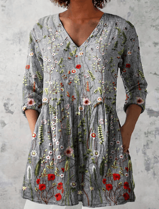Amelie long blouse with V-neck by THE WHITMORE FAMILY, featuring lightweight fabric and a relaxed fit, displayed on a hanger.