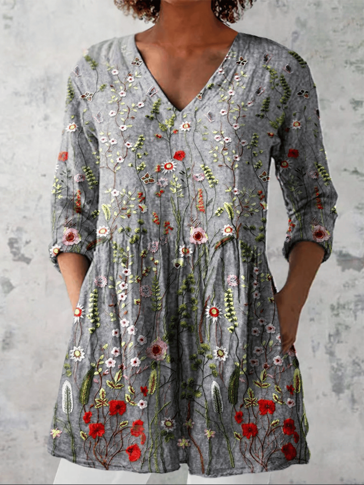 Amelie long blouse with V-neck by THE WHITMORE FAMILY, featuring lightweight fabric and a relaxed fit, displayed on a hanger.