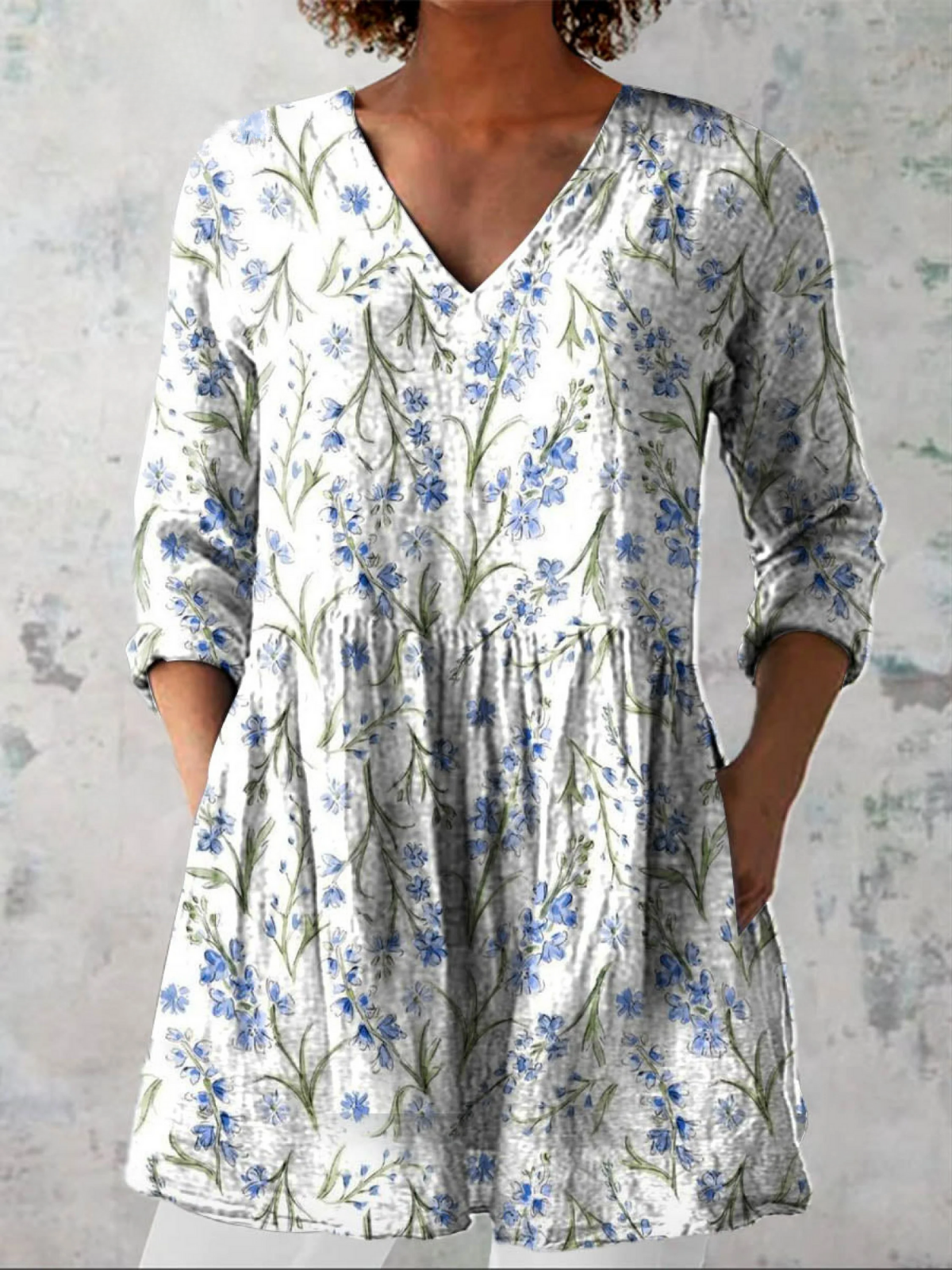Long Jeanne blouse with V-neck by THE WHITMORE FAMILY, featuring flowing fabric and elegant design.