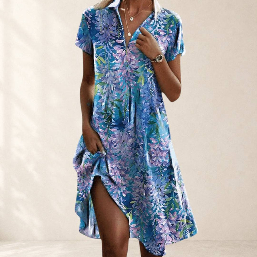 Elegant Firi Chic Dress by THE WHITMORE FAMILY, featuring a stylish design and flowing fabric, displayed on a mannequin.