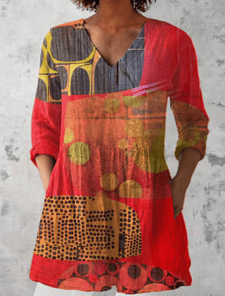 Long V-neck blouse named Lucie by THE WHITMORE FAMILY, shown in a flowing fabric with long sleeves and a relaxed fit.