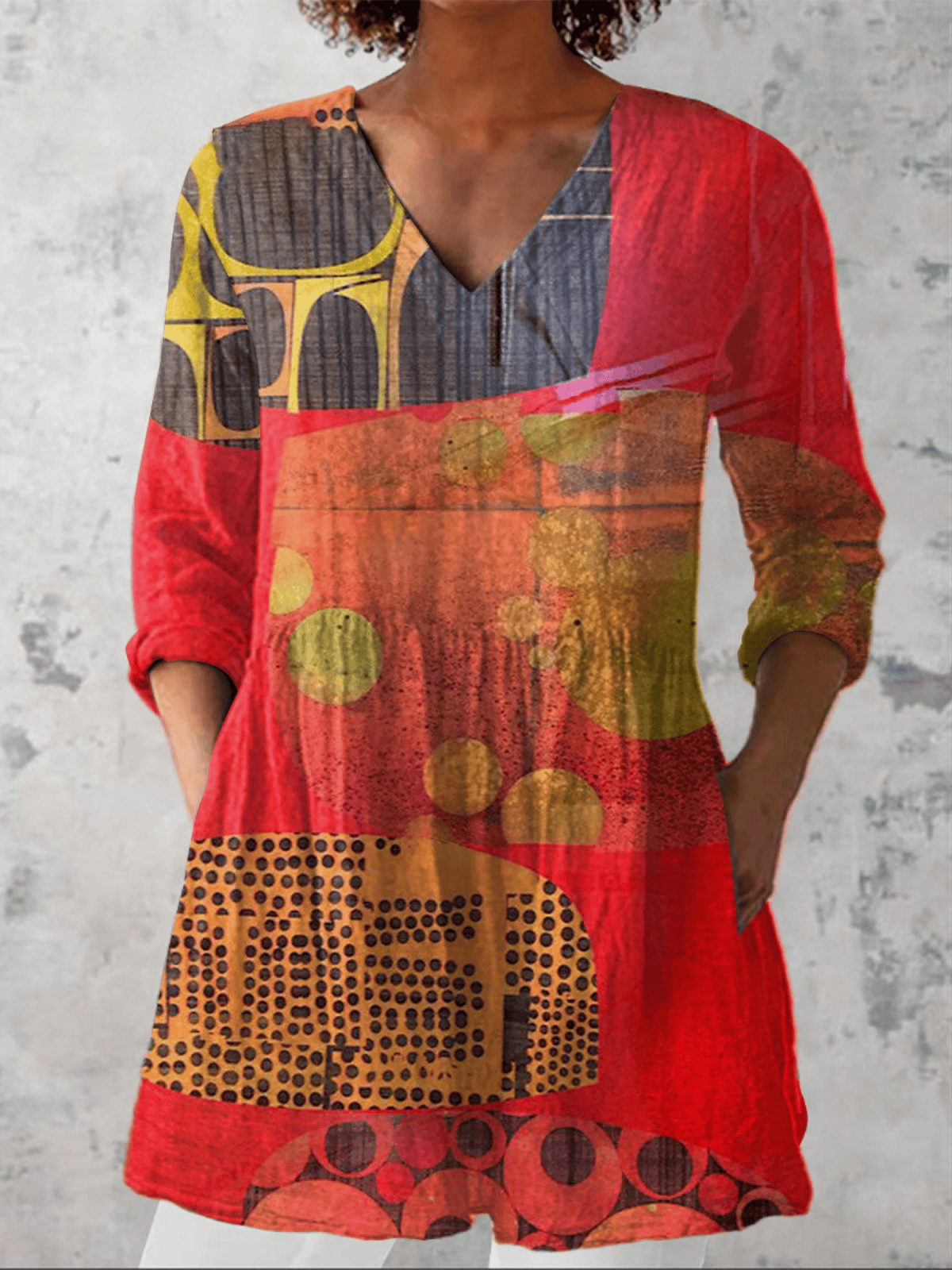 Long V-neck blouse named Lucie by THE WHITMORE FAMILY, shown in a flowing fabric with long sleeves and a relaxed fit.