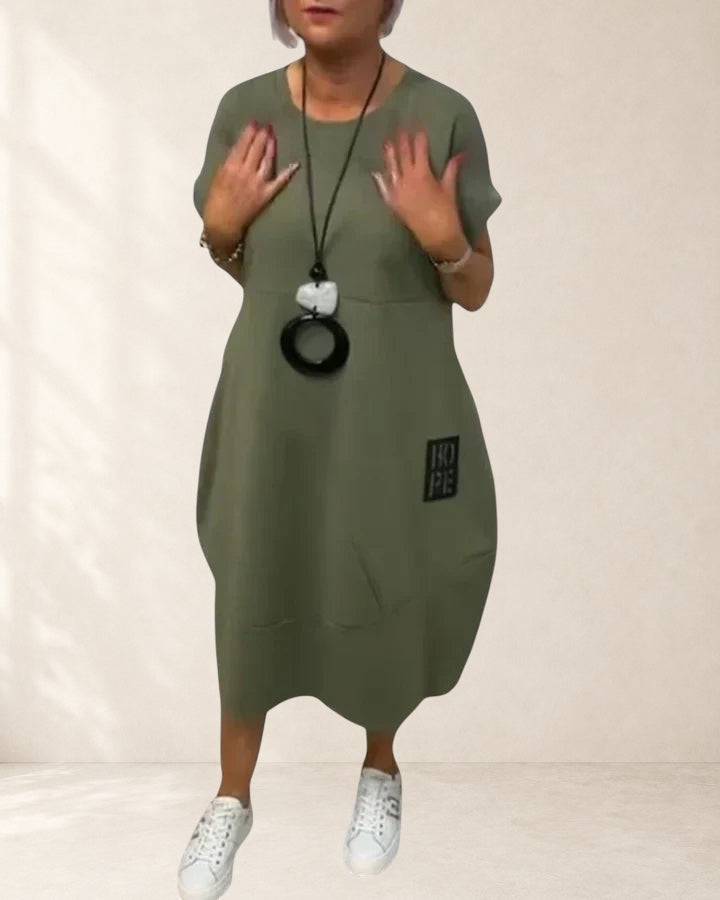 Thalyssiah comfortable midi dress by THE WHITMORE FAMILY, shown in soft fabric, fitted waist, and knee-length design.