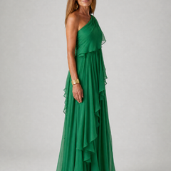 Talia cascading ruffle maxi dress by THE WHITMORE FAMILY, showing flowing fabric and layered ruffle details in a full-length view.