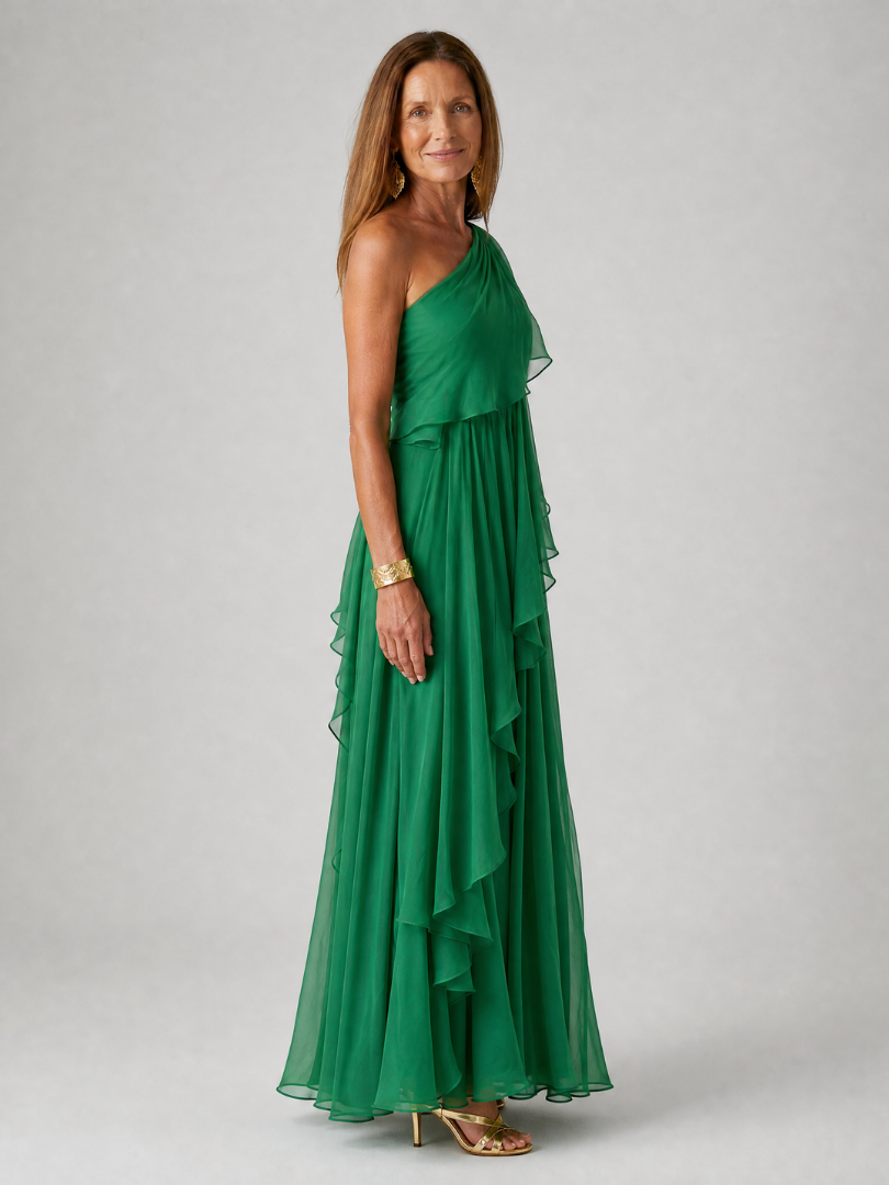 Talia cascading ruffle maxi dress by THE WHITMORE FAMILY, showing flowing fabric and layered ruffle details in a full-length view.