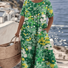 Elegant floral summer midi dress from THE WHITMORE FAMILY, featuring a flowing design and vibrant flower pattern.