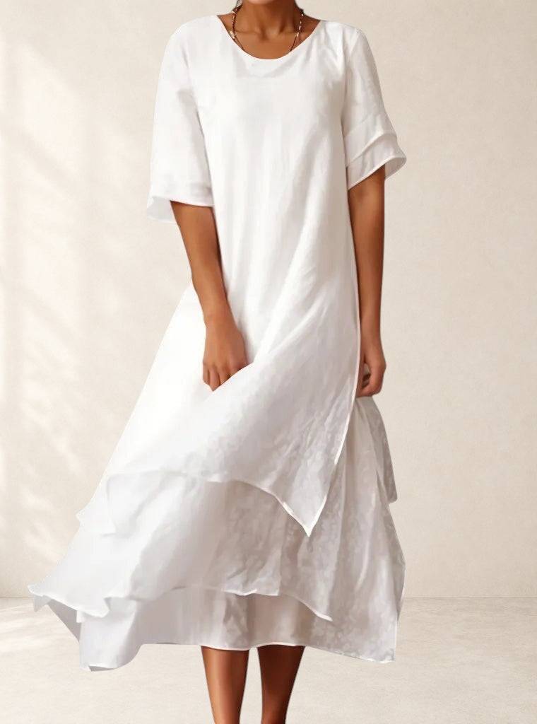 Elegant April™ dress by THE WHITMORE FAMILY, showcasing a stylish, flowing design in soft fabric with detailed neckline.