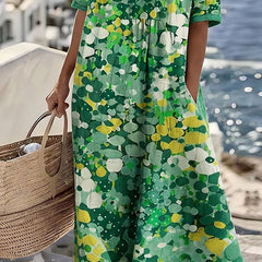 Elegant floral summer midi dress from THE WHITMORE FAMILY, featuring a flowing design and vibrant floral pattern.