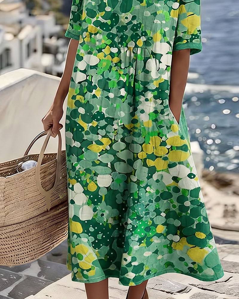 Elegant floral summer midi dress from THE WHITMORE FAMILY, featuring a flowing design and vibrant floral pattern.