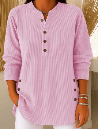 Cream-colored button Henley sweater tunic for women by THE WHITMORE FAMILY, featuring a ribbed collar and long sleeves.