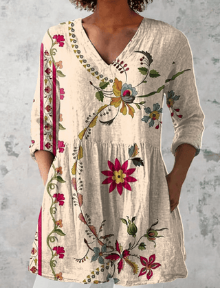 Clara long blouse with V-neck from THE WHITMORE FAMILY, featuring a flowing fabric and elegant design.