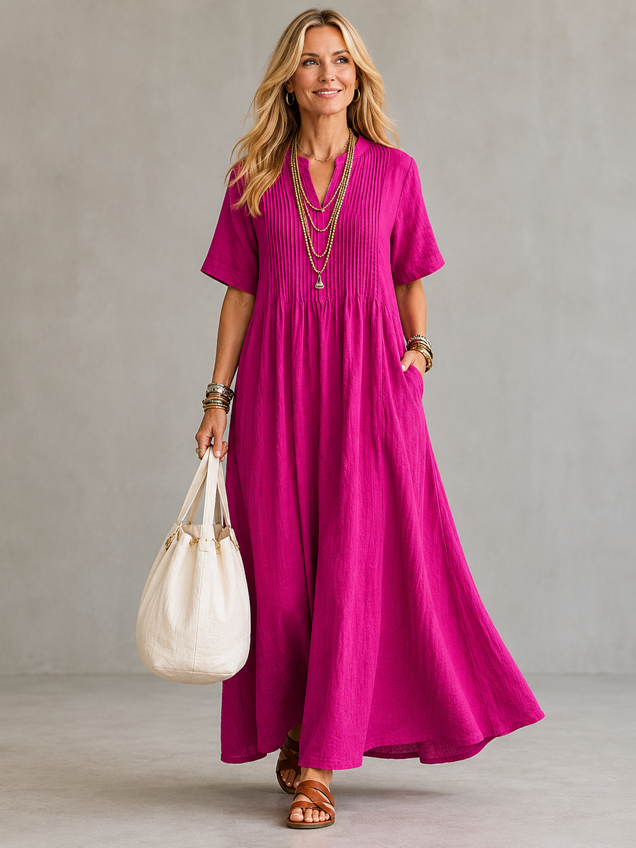 Nathalia™ pleated dress by THE WHITMORE FAMILY featuring a flowy, lightweight fabric with a fitted waist and elegant pleats.
