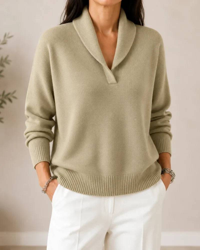 Soft V-neck women's sweater by THE WHITMORE FAMILY, featuring a cozy knit fabric and a relaxed fit in a neutral color.