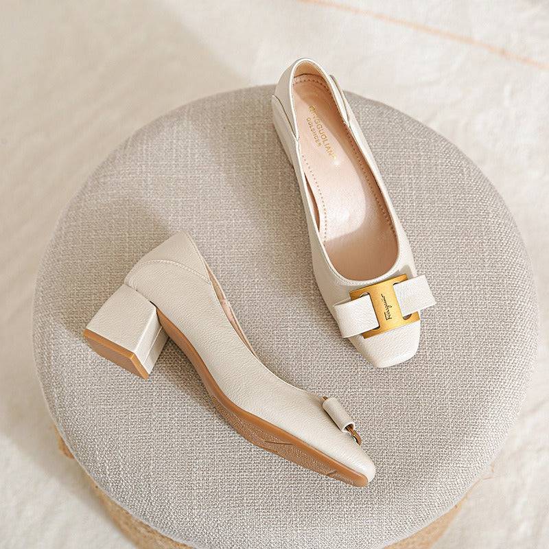 Elegant Lucia Heels by THE WHITMORE FAMILY featuring sleek black leather and stylish high heels on a neutral background.