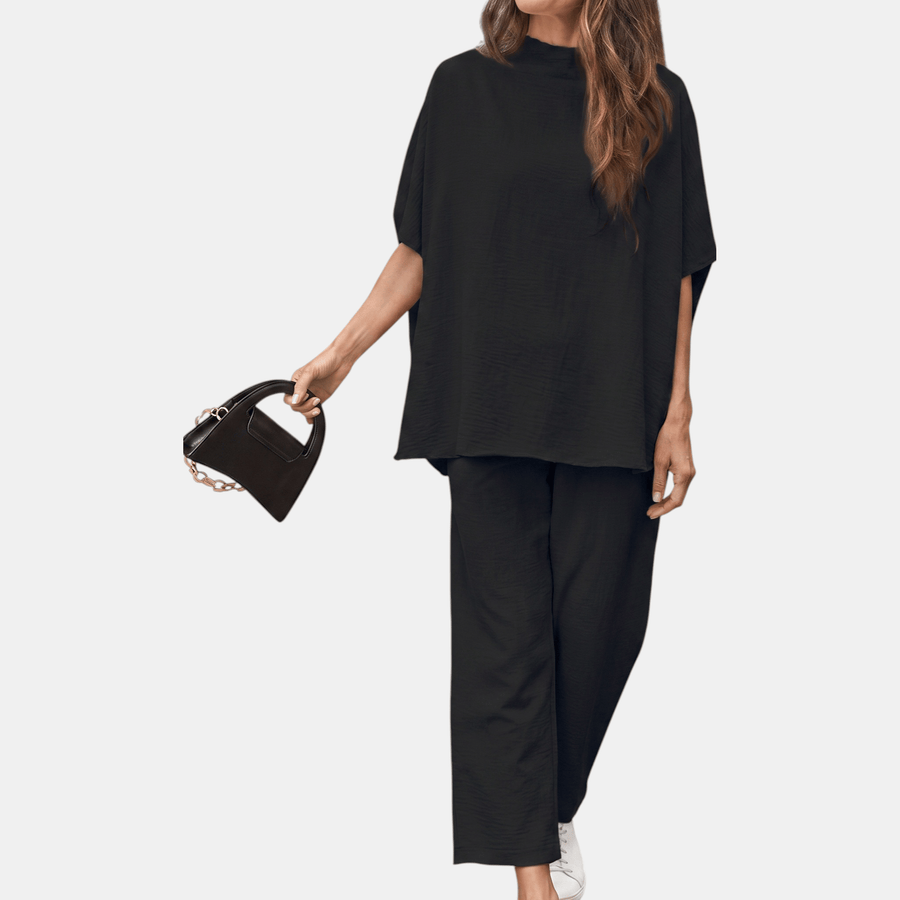 Black women's mock neck lounge set with wide-leg cropped pants by THE WHITMORE FAMILY, shown flat on a white background.
