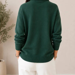Soft V-neck women's sweater by THE WHITMORE FAMILY, featuring a cozy knit fabric and a relaxed fit in a neutral color.