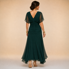 Elegant maxi party dress by THE WHITMORE FAMILY featuring flowing fabric, fitted bodice, and stylish design for special occasions.