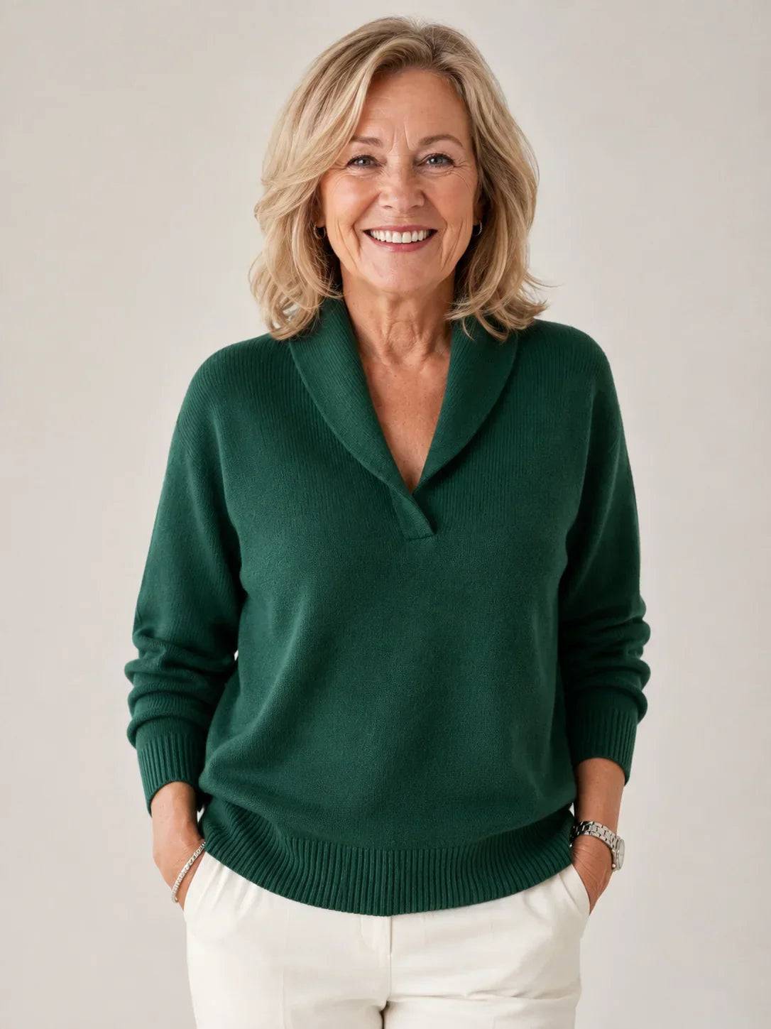Soft V-neck women's jumper sweater by THE WHITMORE FAMILY, showcasing a cozy, light-colored knit with a relaxed fit.