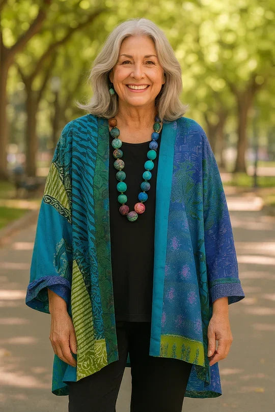 Astrid elegant drape cardigan by THE WHITMORE FAMILY, featuring soft fabric, open front, and flowing silhouette, displayed on a hanger.