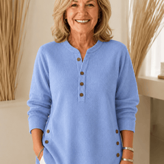 Button Henley tunic sweater for women by THE WHITMORE FAMILY, featuring a cozy knit fabric and a classic button-front design.