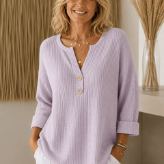 Women’s Henley button sweater by THE WHITMORE FAMILY, shown in a cozy knit with a button-up neckline and long sleeves.