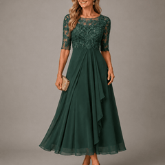 Rosa lace midi dress by THE WHITMORE FAMILY featuring intricate lace fabric and a flowing silhouette on a model.