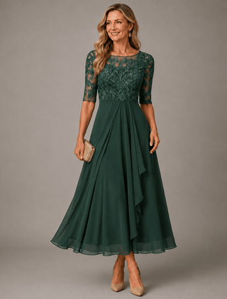 Rosa lace midi dress by THE WHITMORE FAMILY featuring intricate lace fabric and a flowing silhouette on a model.