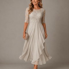 Rosa lace midi dress by THE WHITMORE FAMILY, featuring delicate lace fabric and a fitted silhouette, shown on a hanger.