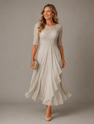 Rosa lace midi dress by THE WHITMORE FAMILY, featuring delicate lace fabric and a fitted silhouette, shown on a hanger.