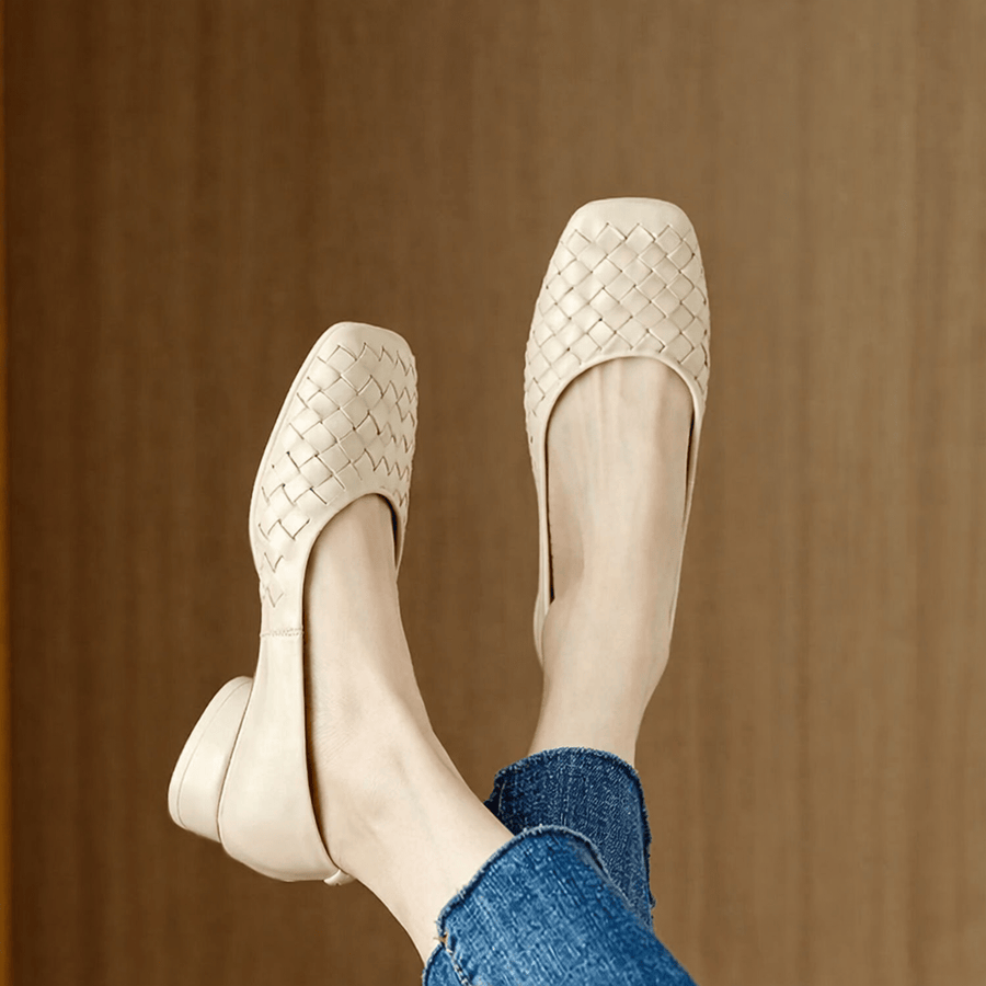 Black Marcelle leather flats by THE WHITMORE FAMILY with rounded toes and smooth finish, displayed on a neutral background