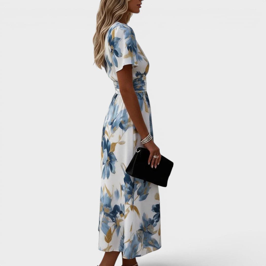 Floral wrap midi dress from THE WHITMORE FAMILY featuring a waist tie and vibrant floral print, modeled by Denise.