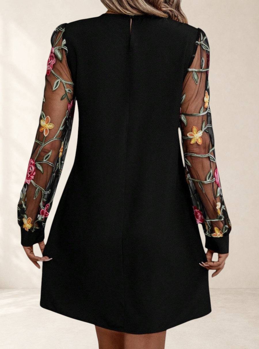 Elegant Jorli™ dress by THE WHITMORE FAMILY featuring intricate design and flowing fabric, perfect for sophisticated occasions.