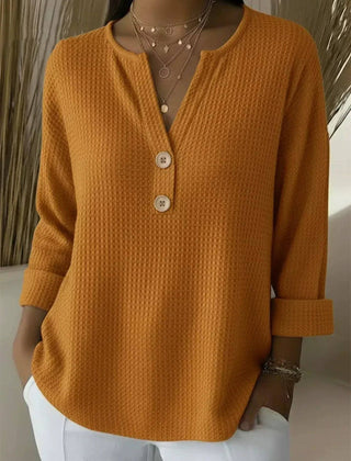 Orange women's Henley button top sweater by THE WHITMORE FAMILY, featuring a cozy knit design and buttoned front.
